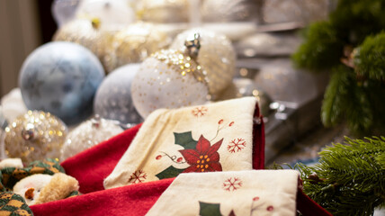 Christmas ball snow-covered fir tree, close-up, blurred bokeh background. Christmas background for a postcard. Decoration for a Christmas tree, spruce branches, New Year's toys.