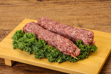 Raw minced beef kebab skewer