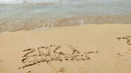 inscription 2020  2021 on beach sand