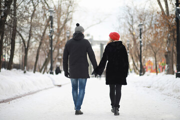 Young couple walking through the winter