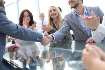 business partners shaking hands during a meeting.