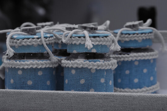 Prepare bonbonniere for a special occasion. Small circular plastic boxes decorated with fabric, rope and a small wooden butterfly.