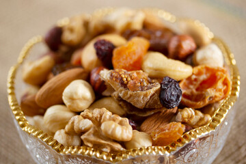 Mixed nuts in a glass plate. Healthy and natural nutrition .Cashew, Almond,, Hazelnut,, Fig,, Walnut,, Apricot,, Raisin,, Blueberry.