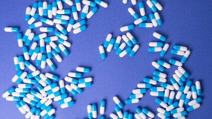 white and blue pills on a blue background