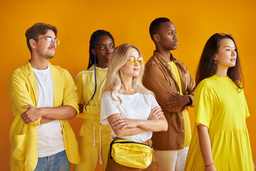 group of multiethnic friends, people of different cultures isolated on yellow background, good-looking men and women in stylish wear posing, students in one country