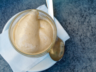 Breakfast at the bar on a warm September day. A cup of cold Italian espresso served on an outdoor table.