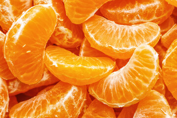 Tangerine segments, orange background texture,Flat lay, top view.healthy citrus fruits with lots of vitamins