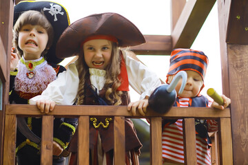 Fototapeta premium Children's party in a pirate style. Children in pirate costumes are playing on Halloween.