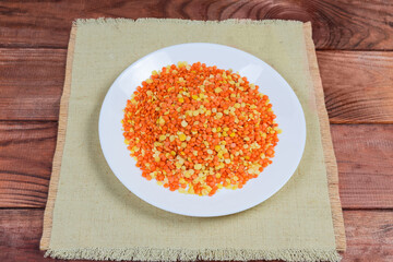 Mix of raw red and yellow split lentils on white dish