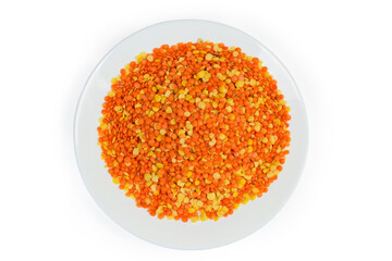 Red and yellow lentils mix on white dish, top view