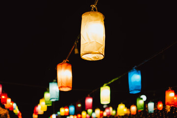 A group of colorful illuminated silk lanterns at night.
 Colorful lanterns, Loy Krathong Festival. 
