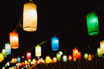 A group of colorful illuminated silk lanterns at night.
 Colorful lanterns, Loy Krathong Festival. 
