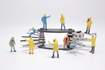 the group of min figure repairing the tool.