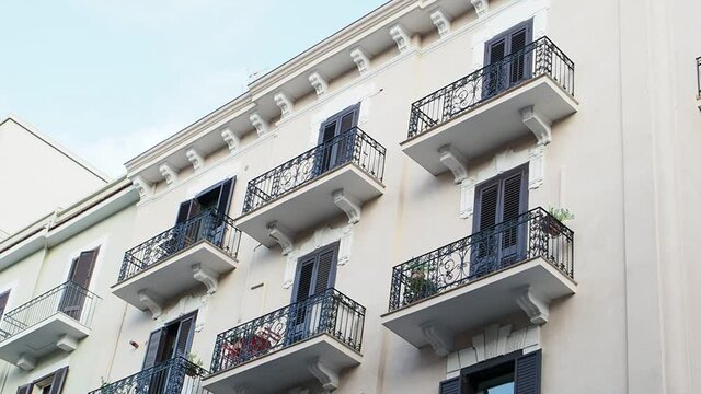 A stroll through the residential district of the city of Bari, in southern Italy. The view of balconies and apartments of a building.