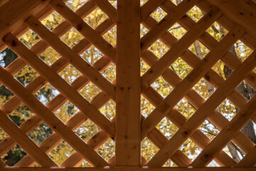 Vintage rustic wooden gazebo grille. Wooden lattice pattern.