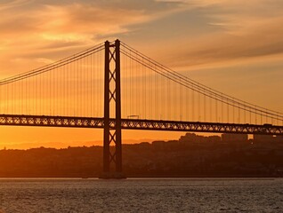Naklejka na ściany i meble 25th of april bridge with evening light in Lisbon - Portugal