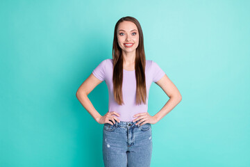 Photo portrait of girl with long hair smiling put hands on waist isolated on vibrant teal color background