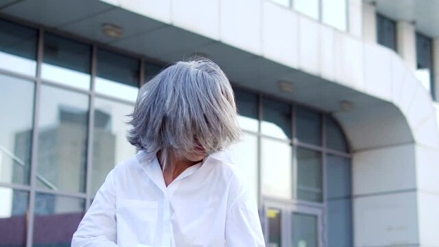 Successful adult business woman having fun jumping and dancing, celebration
