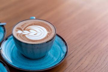 chocolate latte in large cup with tree pattern