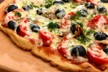 homemade pizza, vegetarian food, baked vegetables and cheese, tomatoes and olives, delicious food on a wooden background