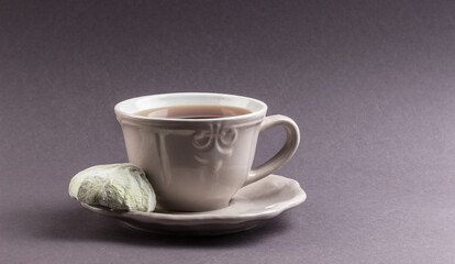 A cup of tea and bean on a neutral background