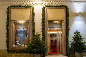 Fototapeta premium Decorating a clothing store window for new year and Christmas
