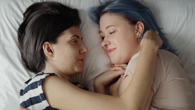 Top view video of lesbian couple together in bed. Shot with RED helium camera in 8K.