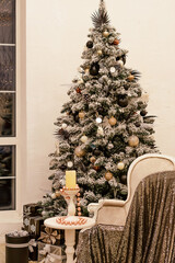 Beautiful light Christmas interior.Creative Christmas tree with black gift boxes and sofa. 