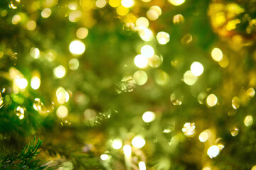 Obraz premium Blurred Christmas tree background in golden light of garlands. Decorations for the new year and christmas, copy space