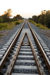 Fototapeta na wymiar rails sleepers railway track at sunset of a summer day