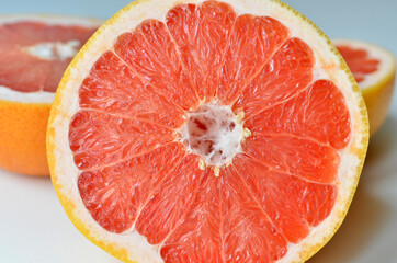 Fresh cut grapefruit fruit on white background