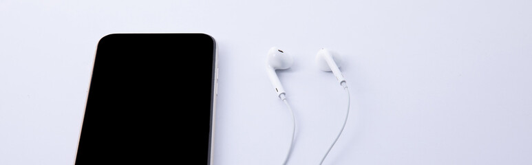 new modern black smartphone new modern black smartphone with earphones isolated on white background, close view with earphones isolated on white background, close view . High quality photo