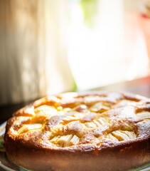 delicious traditional home made apple cake on with a blurred background with focus on a part of the...