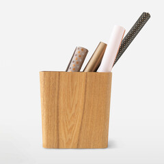 Wrapping paper rolls in a wooden hamper