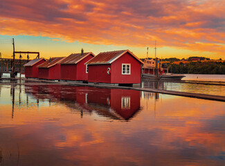 Idyllic small red floating cottages. Location: Fetsund, Norway