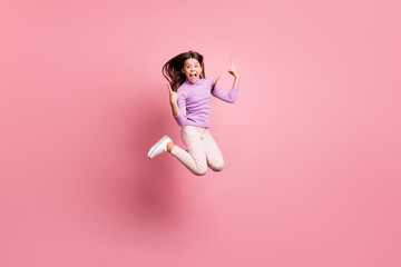 Full size photo of crazy small kid girl jump show horns symbol wear purple sweater isolated on pastel color background