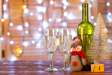 Christmas background with glasses and a bottle on the table.