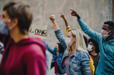Group of people activists protesting on streets, strike and demonstration concept.