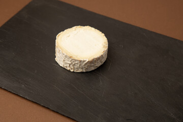 goat cheese on brown background