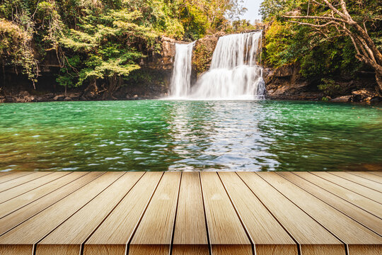 Empty top wooden table on beautiful waterfall in deep forest © AungMyo