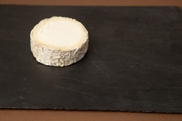 goat cheese on brown background