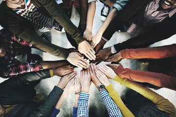 Aerial view of diverse people stacking hands in the middle - Powered by Adobe