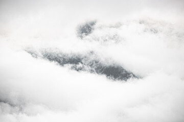 swiss mountains in the clouds, foggy weather in Switzerland