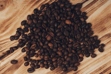 Roasted coffee beans on rustic wood background