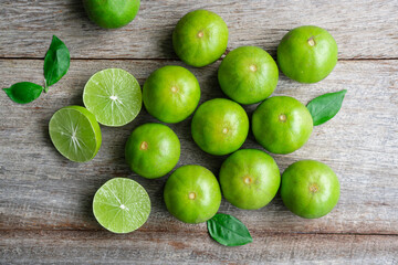 Top view of fresh citrus lemon lime on wooden background. Flat lay