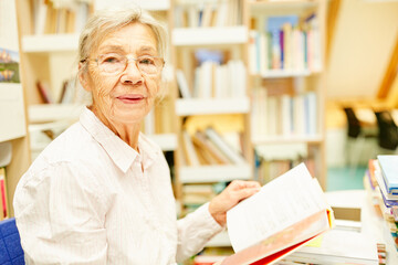 Senior teacher or librarian with book