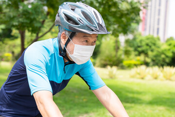 Asian old man riding bicycle