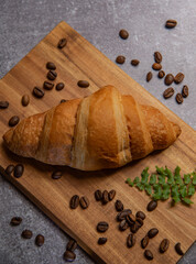 croissant with strawberry jam and coffee beans