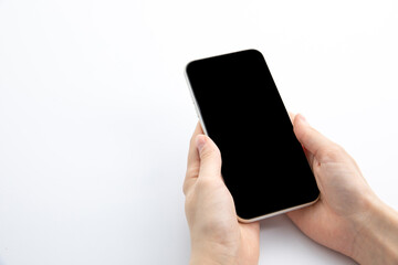 female hands holding new modern black smartphone isolated on white background, close view . High quality photo