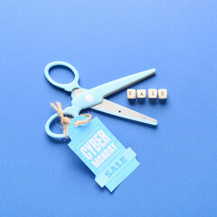 Scissors and shopping tag with text CYBER MONDAY SALE on color background